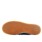 Gum rubber outsole for Nike Air Force 1 sneaker with circular traction pods.