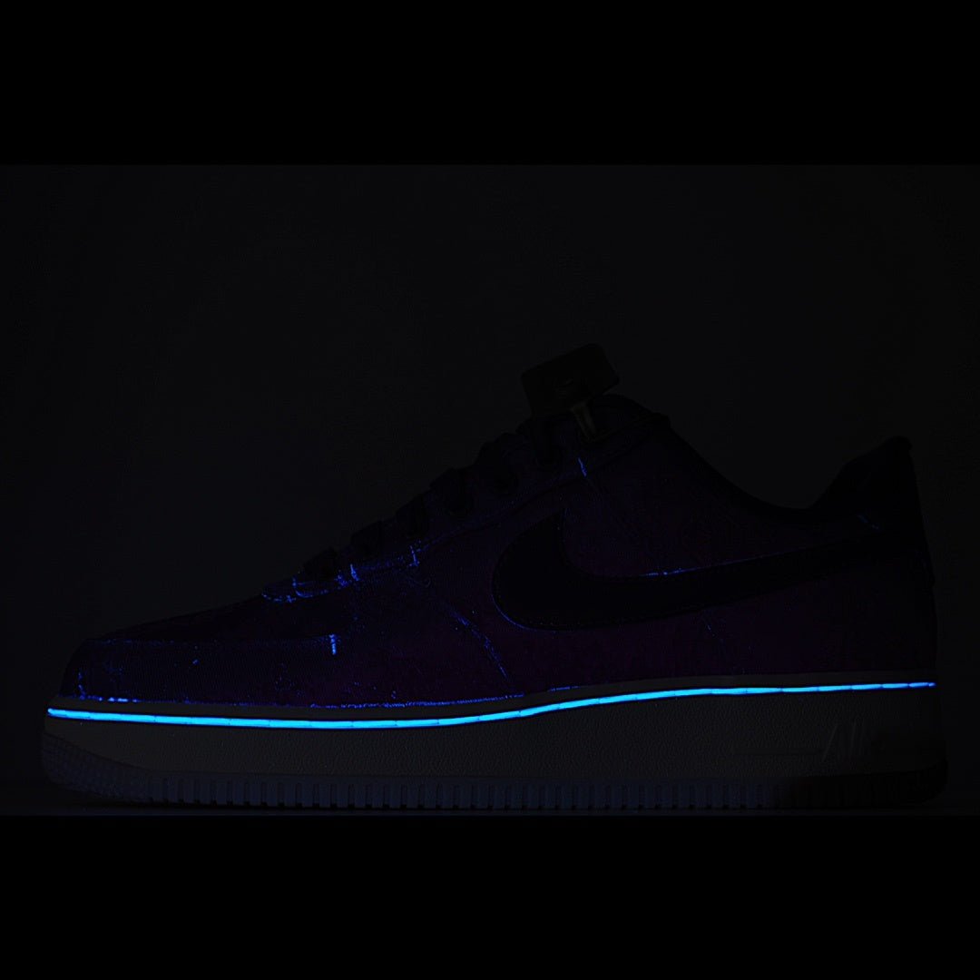Dark blue low-top sneaker with blue accent stitching and white midsole.