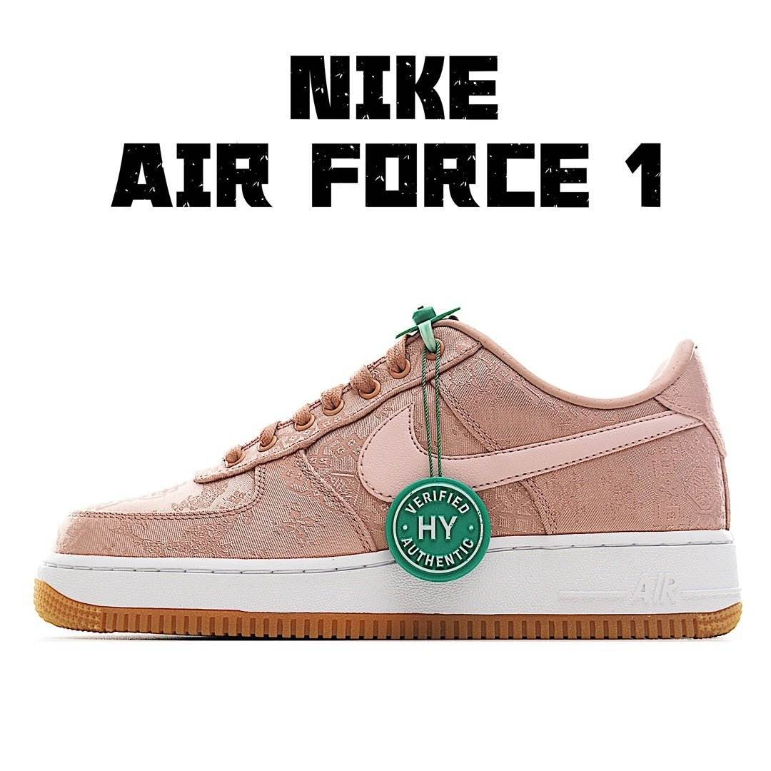 Light pink low-top sneakers with white swoosh, green lace tag, gum outsole.