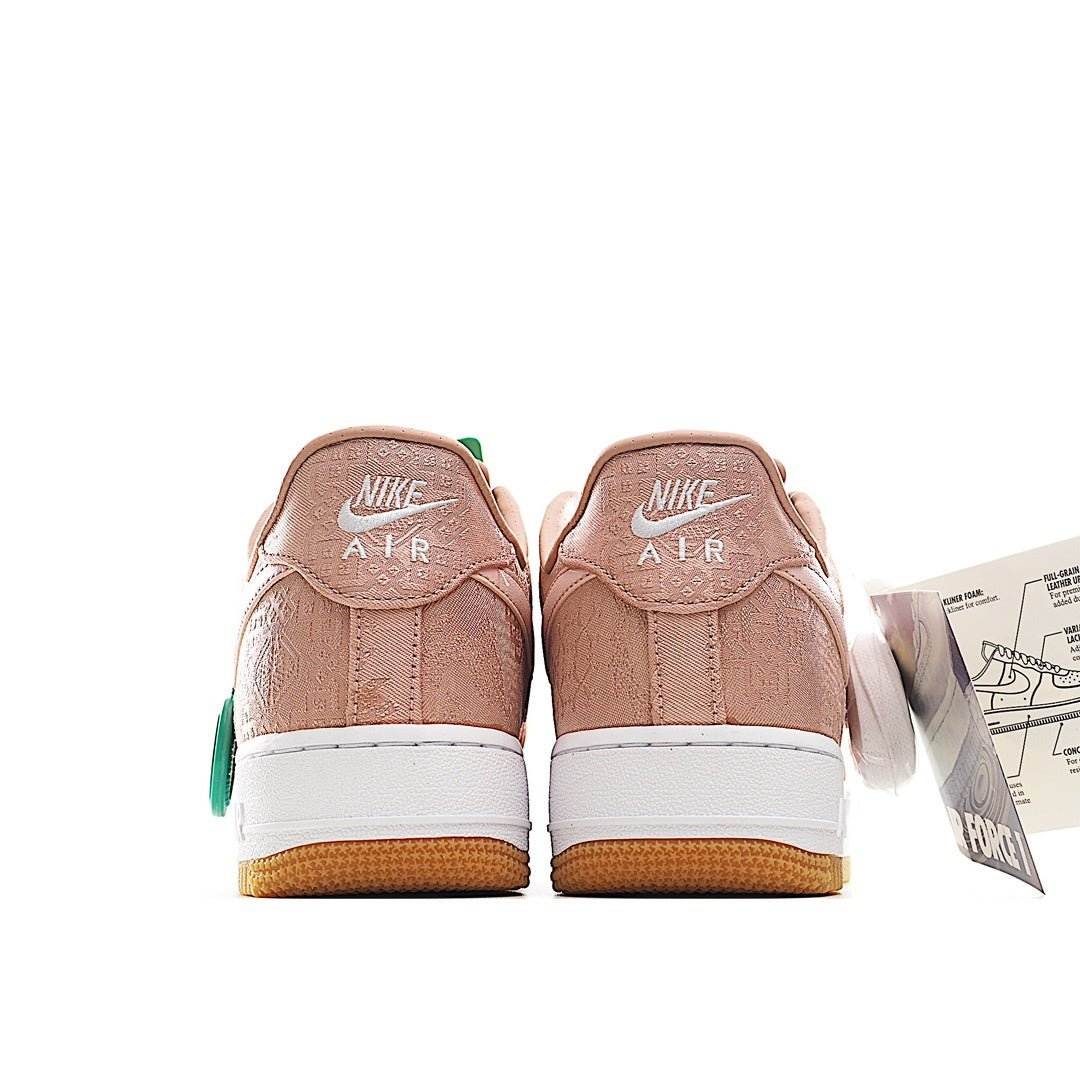 Rose pink low-top sneakers, Nike Air heel text, white midsole, gum outsole.