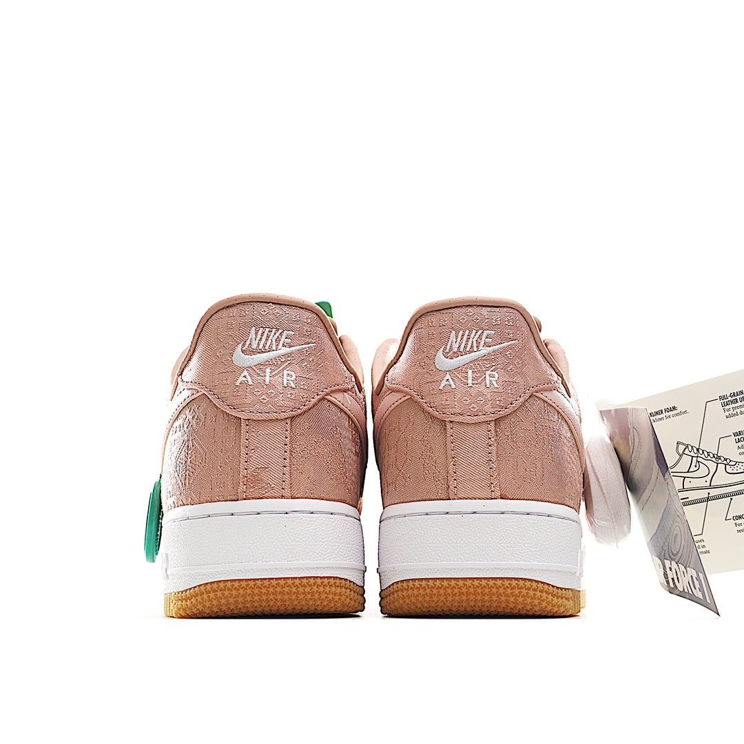 Pair of pink Nike Air Force 1 sneakers with white “NIKE AIR” heel text and gum soles
