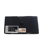 Black shoe box with product label and small sneaker image on the front