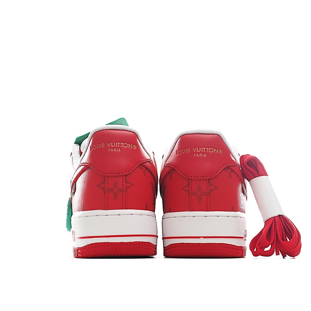 Pair of red-and-white sneakers with green pull tabs at the back.