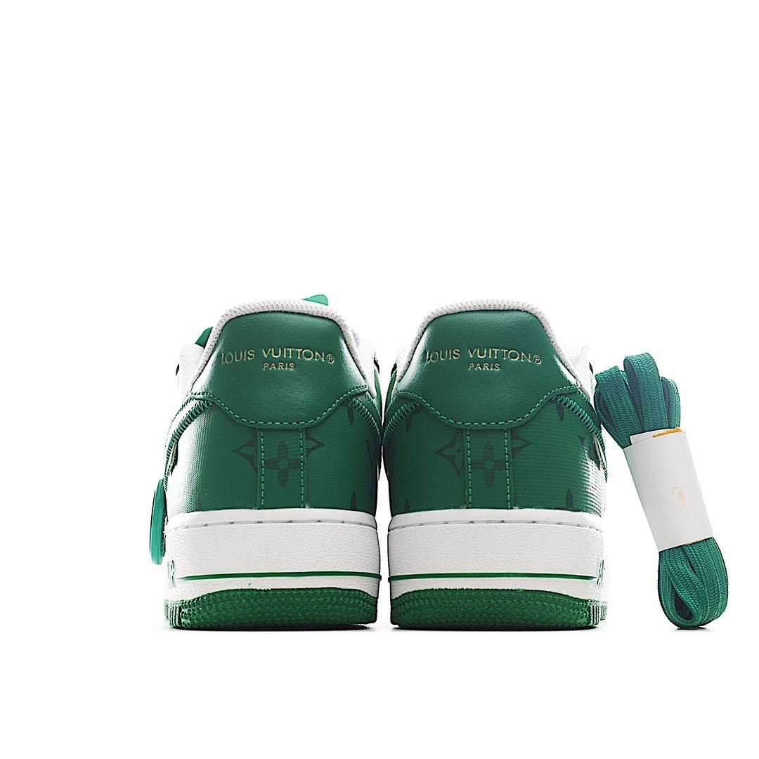 Pair of green leather sneakers with white midsoles and stitched heel tabs