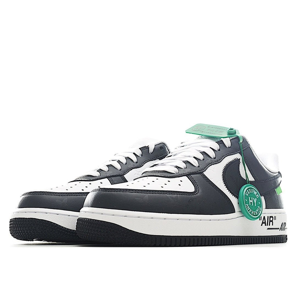 Pair of black and white sneakers with green lace accents and side swoosh, profile