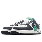 Pair of black and white sneakers with green lace accents and side swoosh, profile