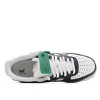 Sneaker interior view with white laces, navy insole, and green hang tag