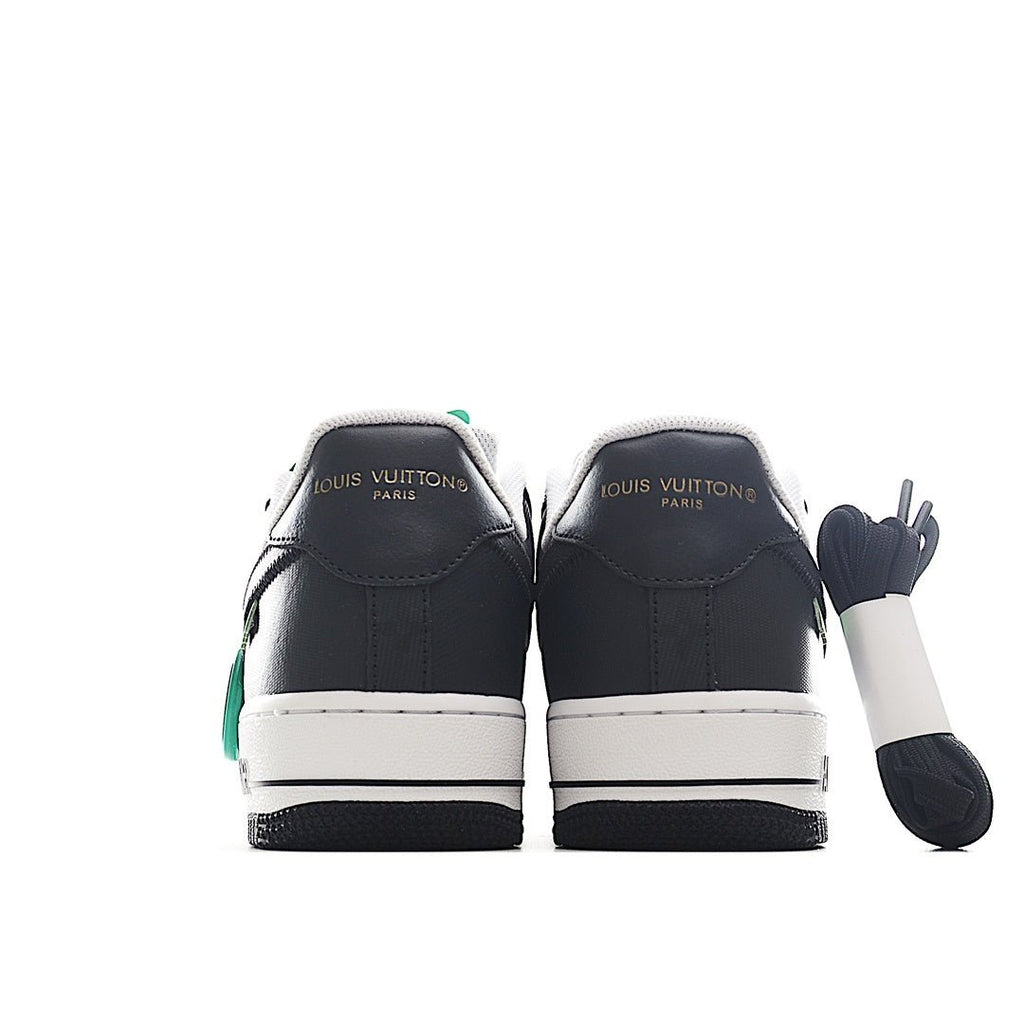 Black and white sneakers with green accents, rear view and white midsoles