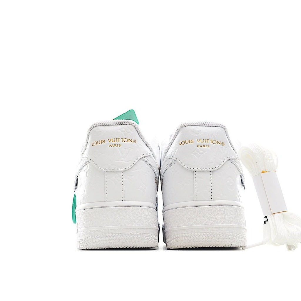 Pair of white Air Force 1 sneakers with mint green heel tags and laces