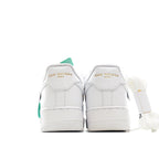 Pair of white Air Force 1 sneakers with mint green heel tags and laces