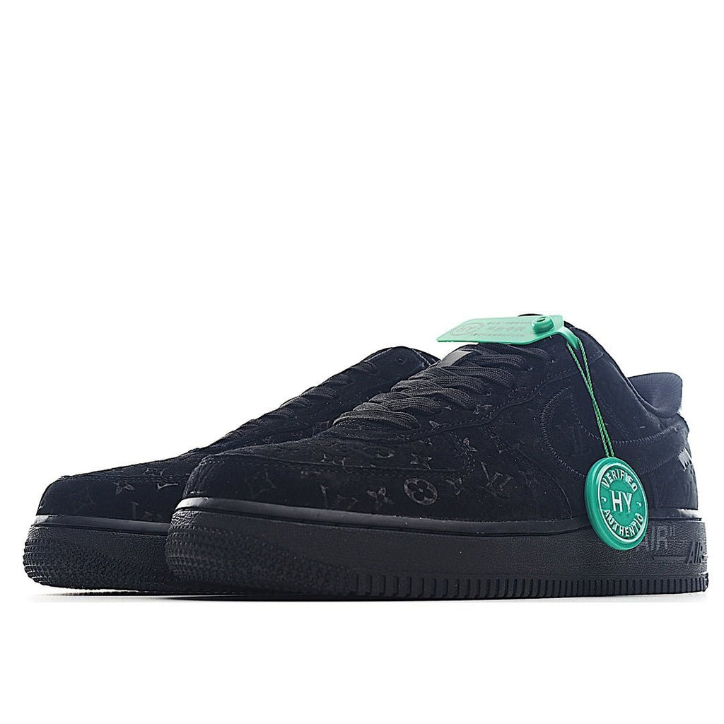 Black low-top sneaker profile with green pull tab and textured logo print