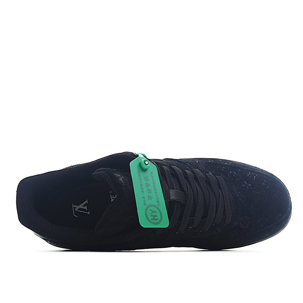 Black low-top lace-up sneaker with green lace tag and ribbed side lacing