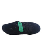 Black low-top lace-up sneaker with green lace tag and ribbed side lacing