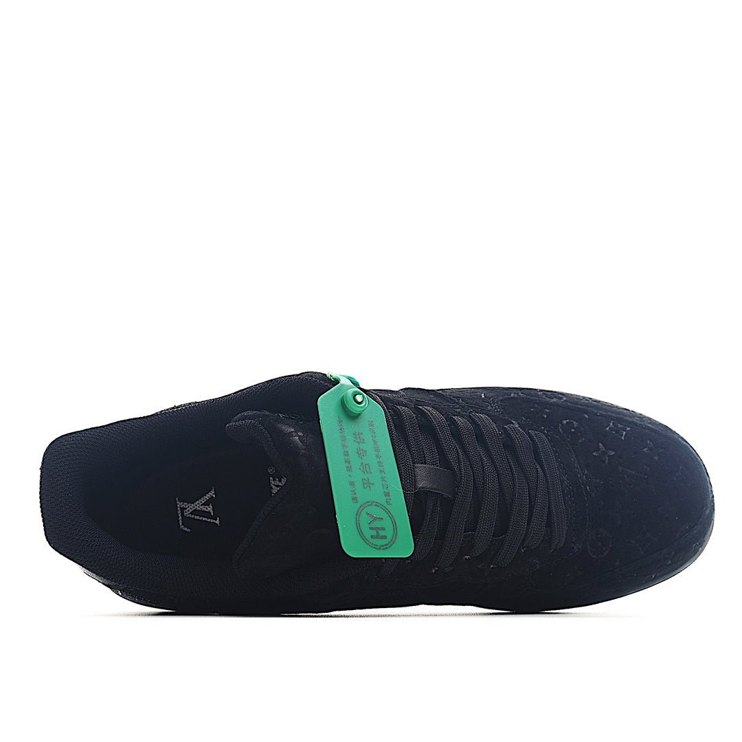 Black low-top lace-up sneaker with green lace tag and ribbed side lacing
