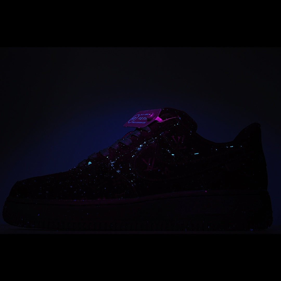 Black low-top sneaker with reflective pattern and green heel tag