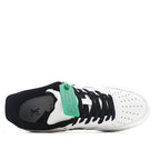 Air Force 1 sneakers, white leather with black laces and green hangtag near tongue