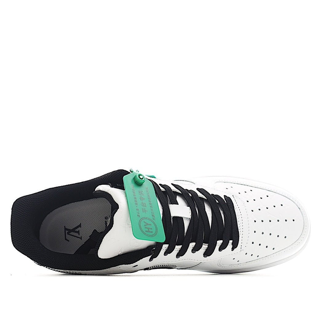Air Force 1 sneakers, white leather with black laces and green hangtag near tongue