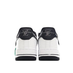 Air Force 1 sneakers, back view with white uppers, black heel counters, green trim