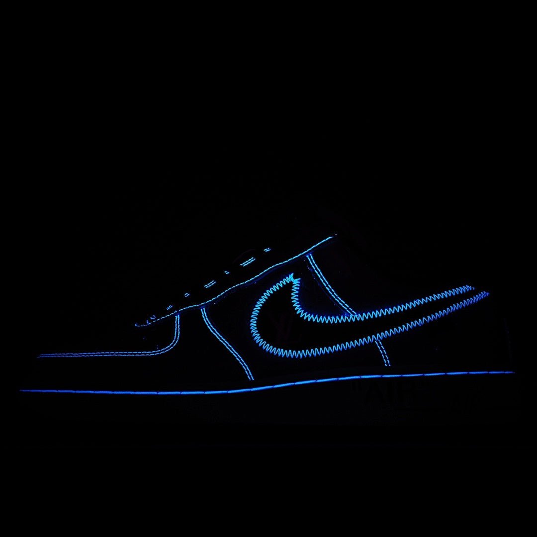 Sneaker side panel with blue neon stitching and outline detail on dark background