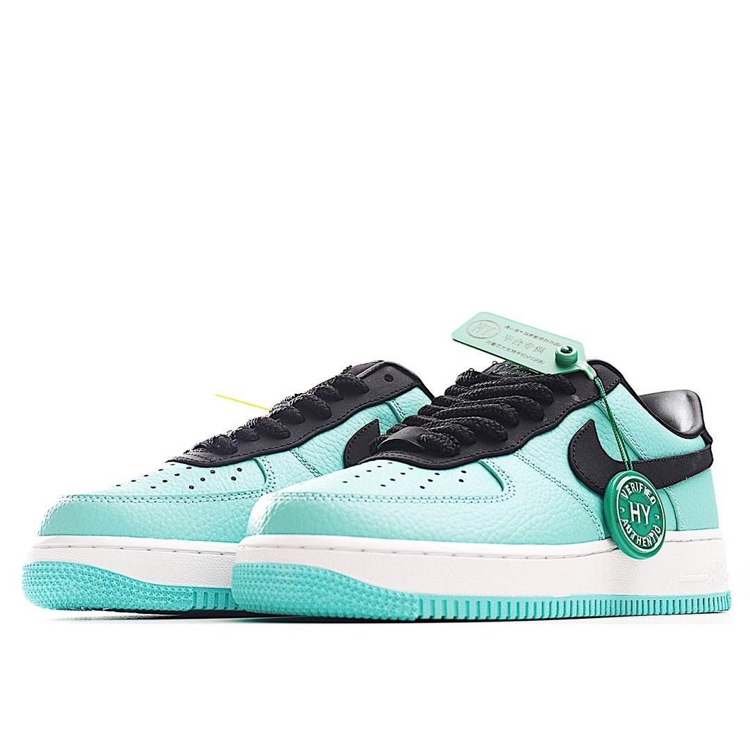 Mint green and black low-top sneakers, side view, black swoosh and lace-up design