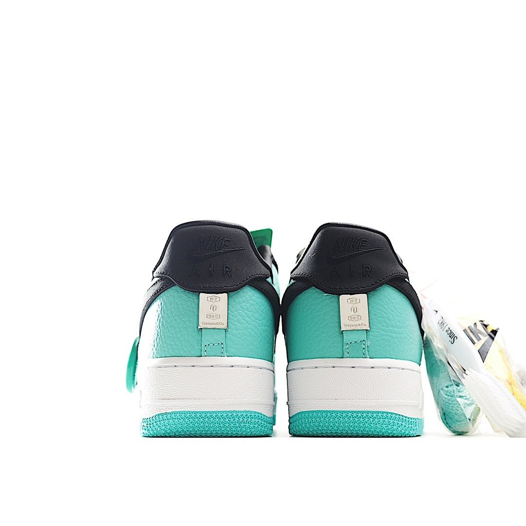Nike Air Force 1 low-top sneakers, teal and white heels with black collar and lace tabs