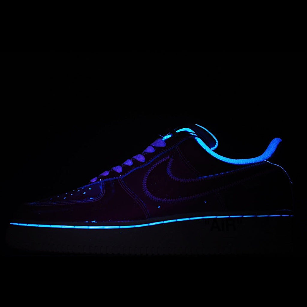 Dark blue Nike Air Force 1 low-top sneaker with neon blue glowing swoosh