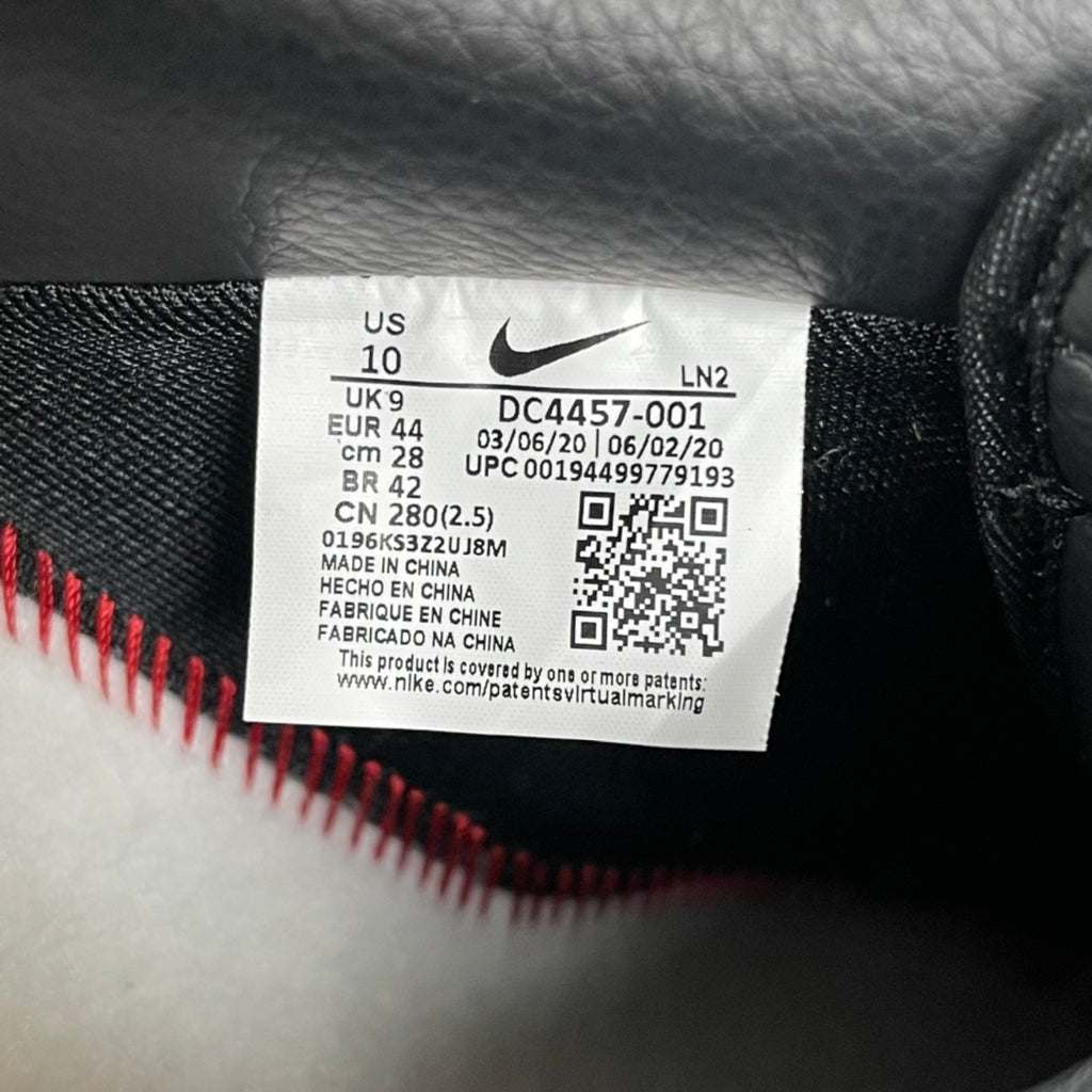 Nike Air Force 1 sneaker size label with barcode on dark upper