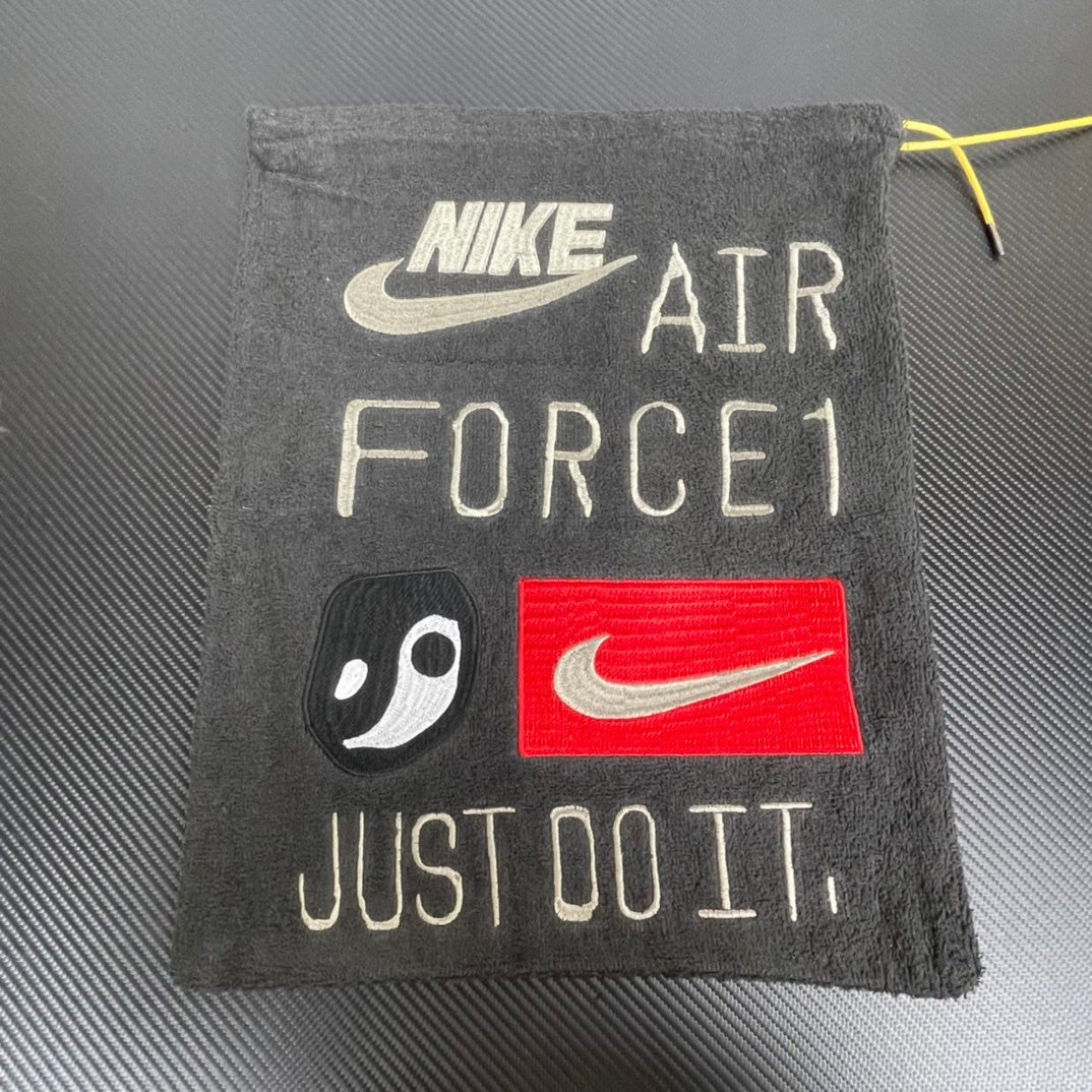 Nike Air Force 1 tongue tag reading “JUST DO IT”, black with red swoosh