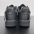 Pair of black sneakers from heel view with NIKE AIR lettering and white sole edge.