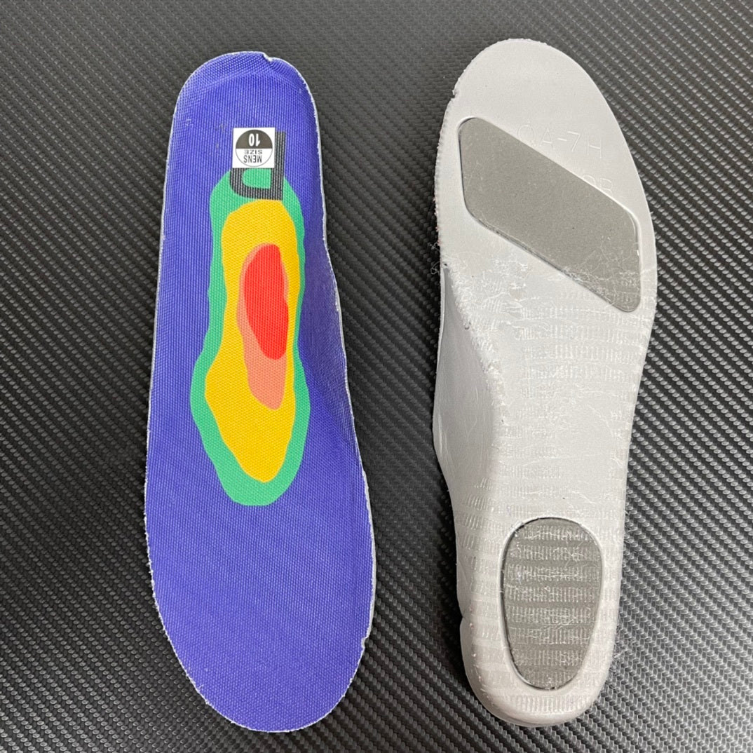 Purple and white shoe insoles shown separately on a dark surface.