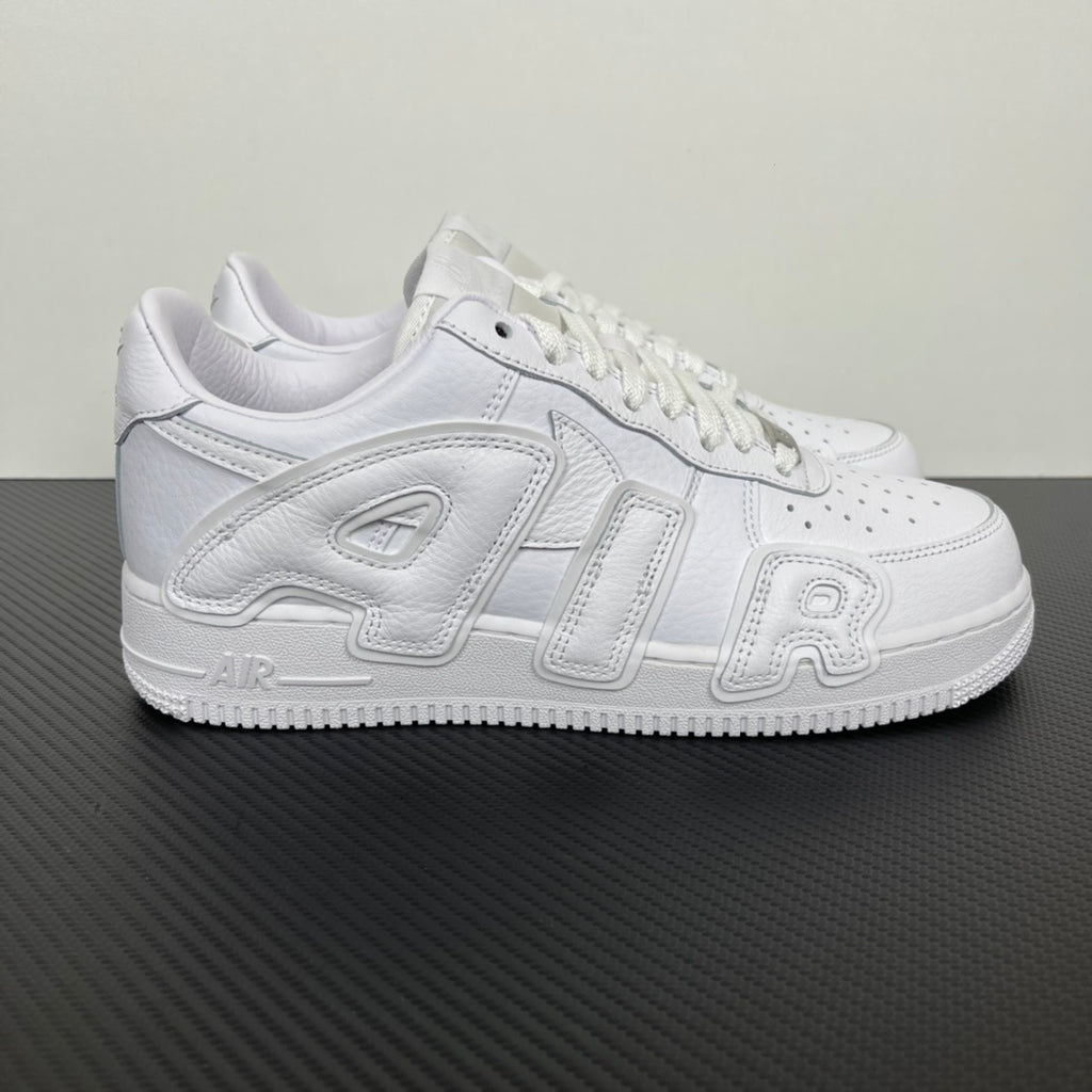 Nike Air Force 1 low-top sneakers in white leather with lace-up front and side overlays.