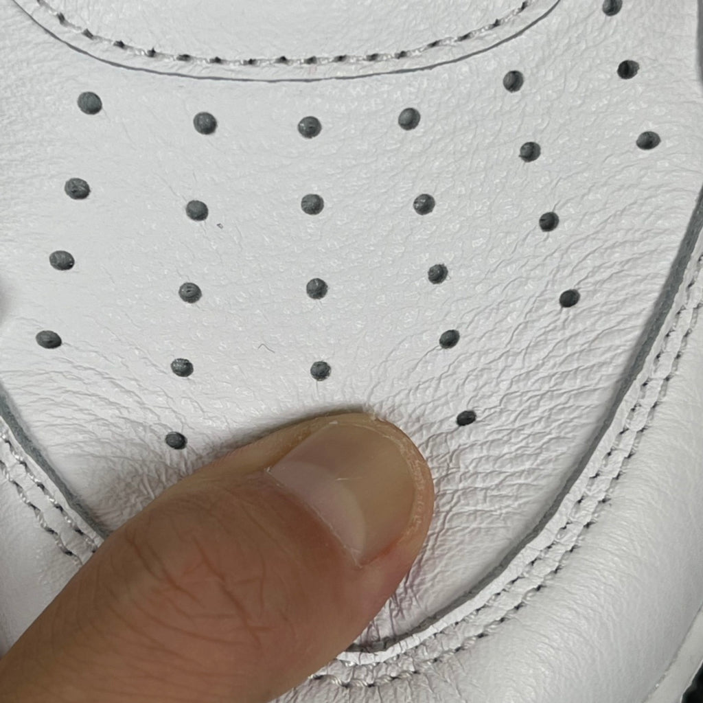 White sneaker toe area with perforations and stitching detail