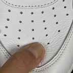 White sneaker toe area with perforations and stitching detail