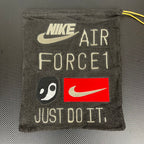 Air Force 1 tongue tag with Nike swoosh and Just Do It branding