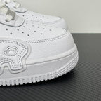 White leather sneaker upper detail with laces, stitched panel, and textured rubber sole edge.