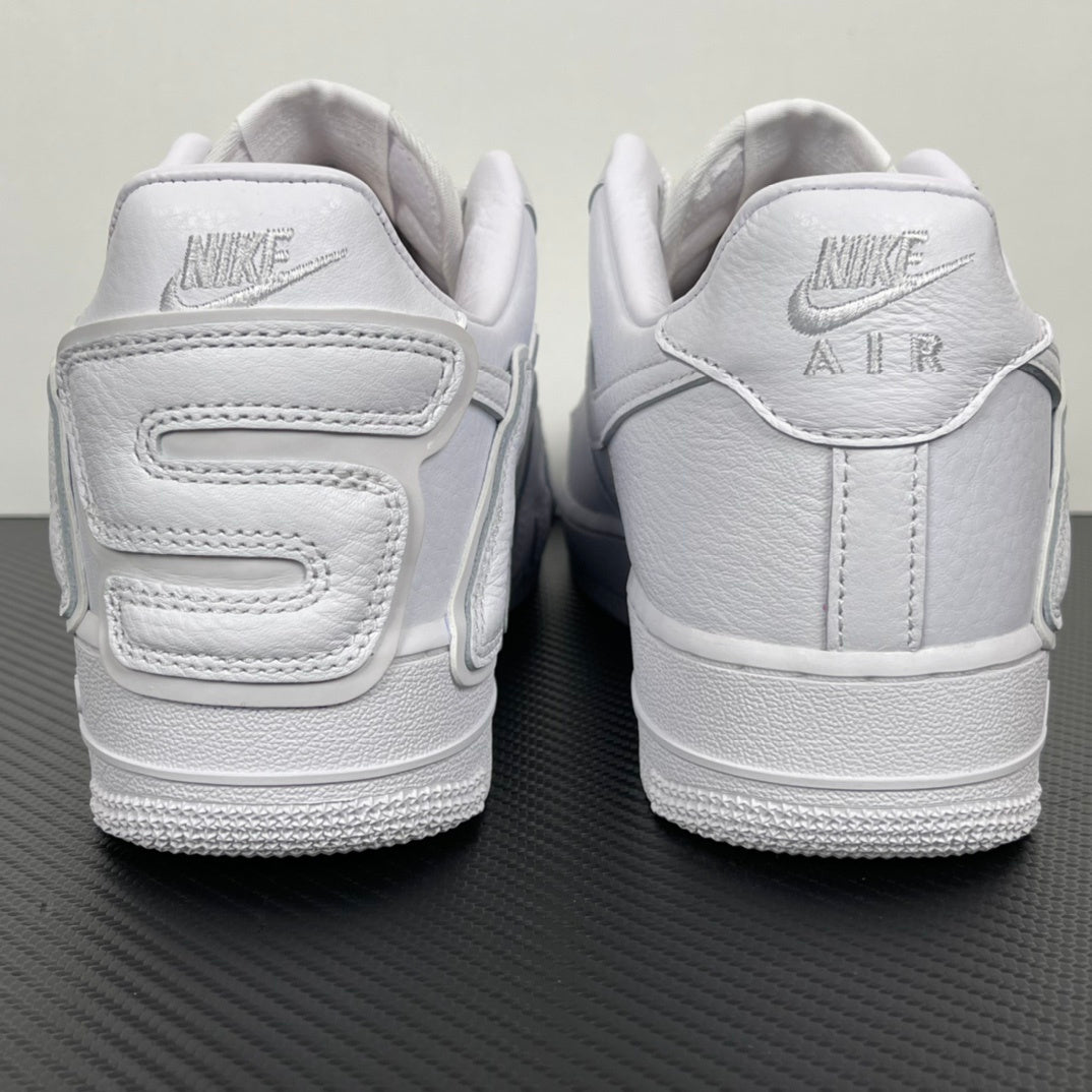 White leather sneaker pair from the heel, showing strap details and Nike Air branding.