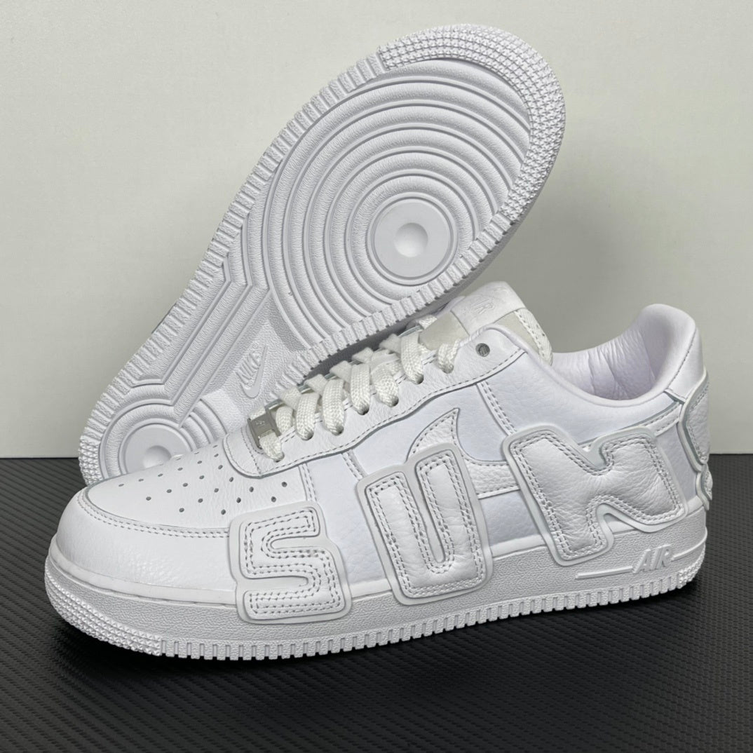 White Nike sneaker from the bottom-left angle with textured outsole and lace-up upper.