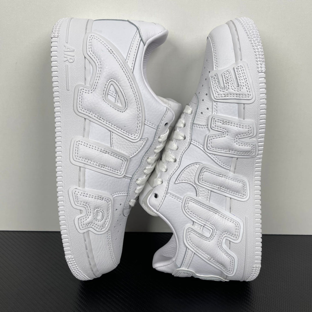 White leather sneakers shown from the side with chunky tread sole and strap-like overlays.