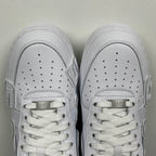 White leather sneaker toe boxes with perforations and lace-up tongues, front view.