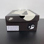 Nike Air Force 1 shoe box with swoosh logo and playful face graphic