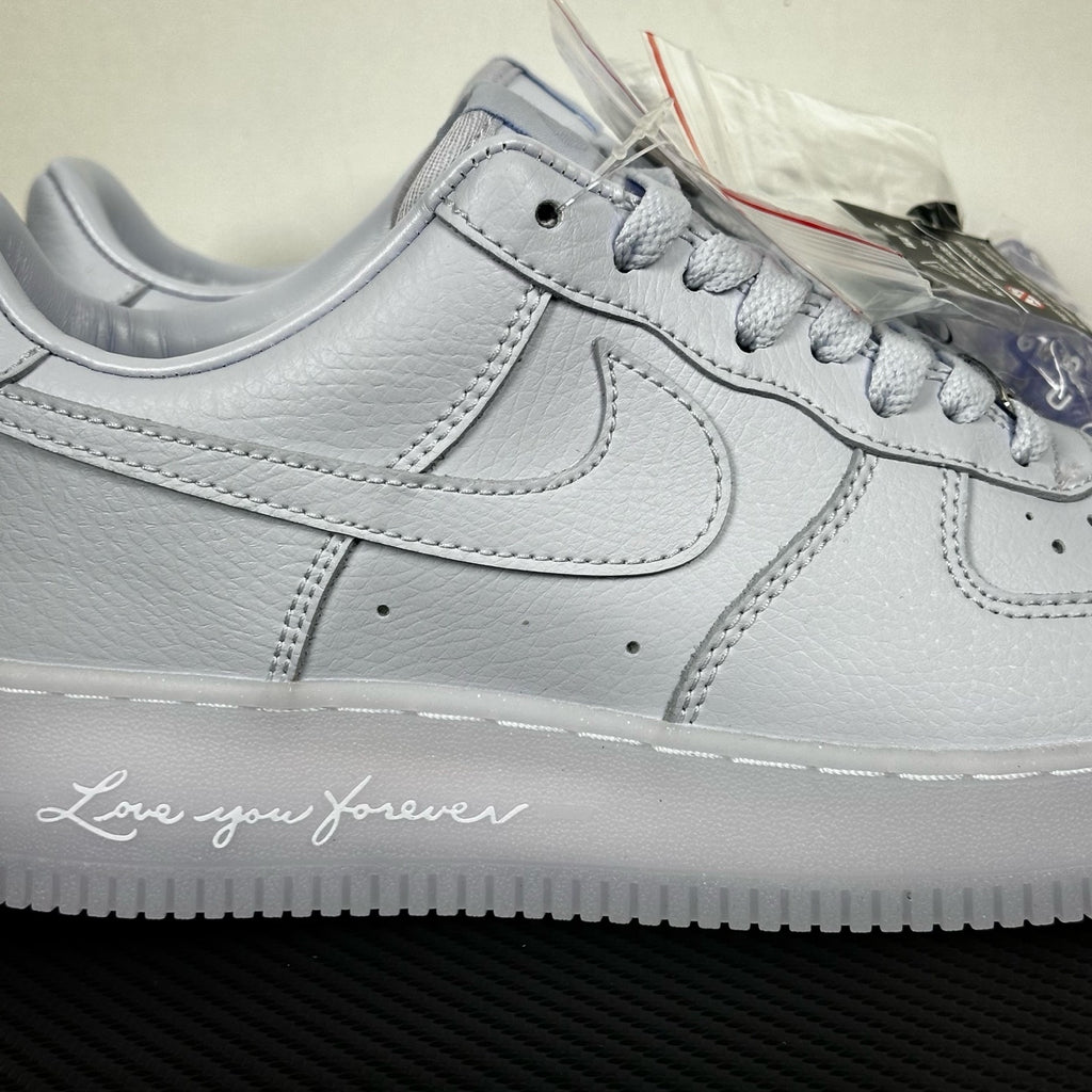 White leather low-top sneaker close-up, Nike swoosh and padded midsole