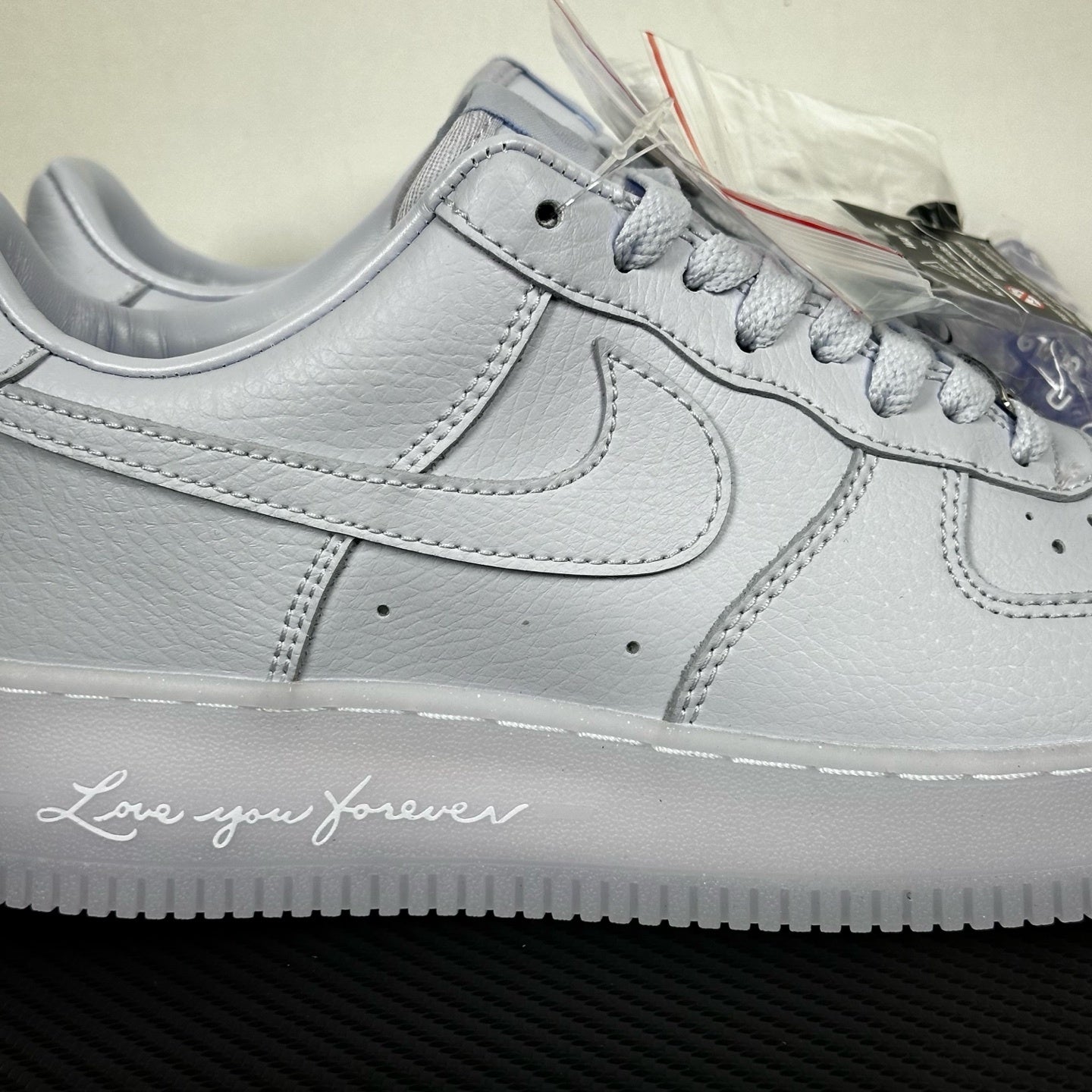 White leather low-top sneaker close-up, Nike swoosh and padded midsole