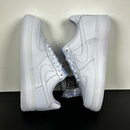 White leather low-top sneakers pair, angled side view, lace-up and swoosh