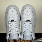White leather low-top sneakers pair, perforated toe box and lace-up front
