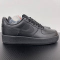 Air Force 1 sneakers in dark gray leather, lace-up with swoosh and textured rubber sole