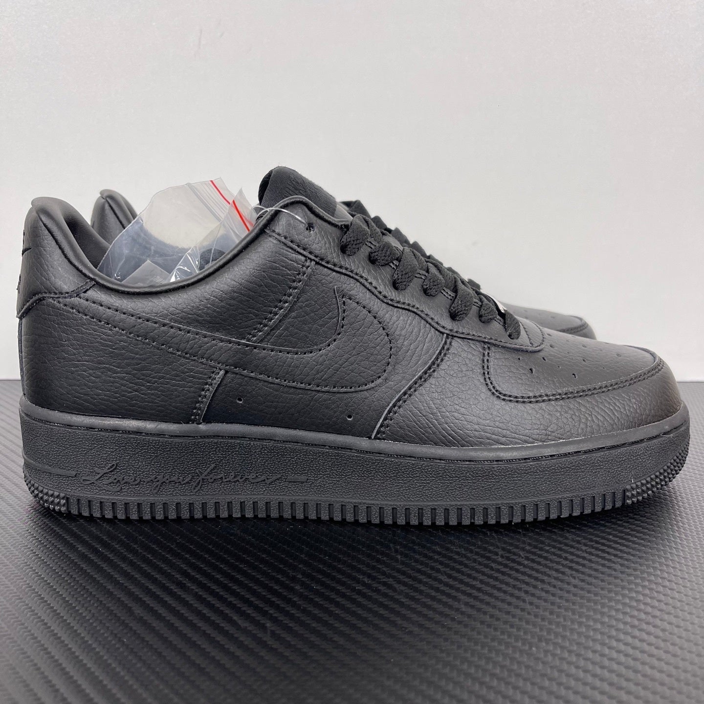 Air Force 1 sneakers in dark gray leather, lace-up with swoosh and textured rubber sole