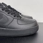 Air Force 1 sneaker side view in dark gray leather, lace-up with swoosh and stitch lines