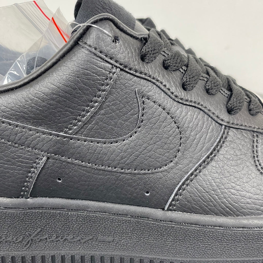 Air Force 1 sneaker upper close-up in dark gray leather, swoosh and lace area stitching