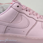 Pink low-top sneaker close-up of swoosh and lace eyelets
