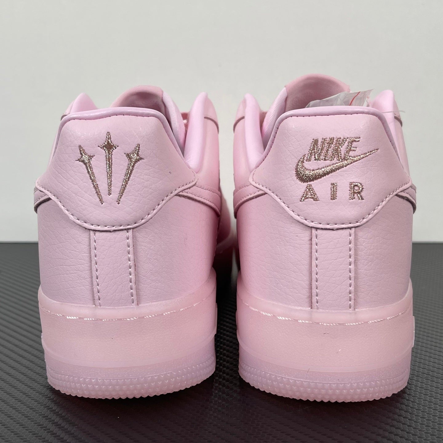 Pink low-top sneakers with Nike Air branding on heel tab